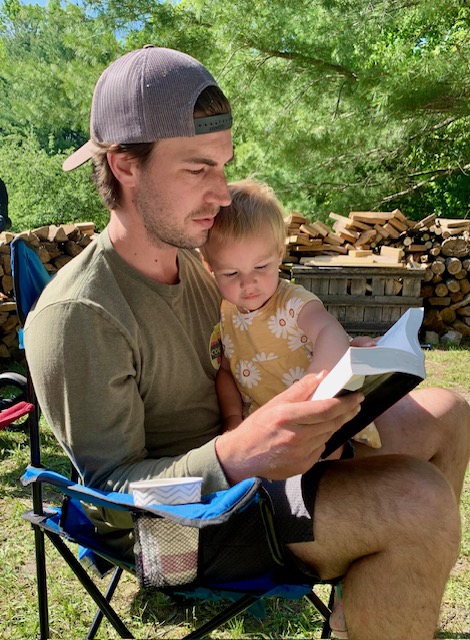 Wyatt reading his bible to his daughter
